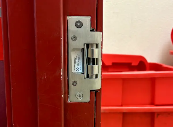 Electric door strike installed on a commercial red door by Mattlock Las Vegas locksmith
