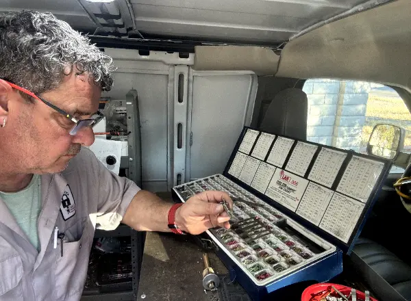 A locksmith rekeying a lock with a pin kit