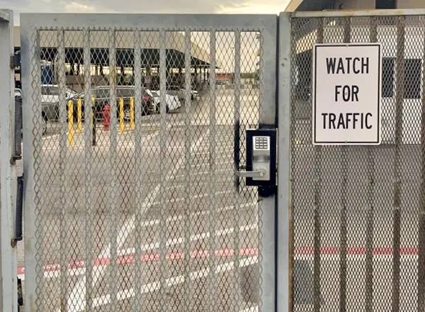 Locksmith service of installing a new high security gate lock on a metal fence