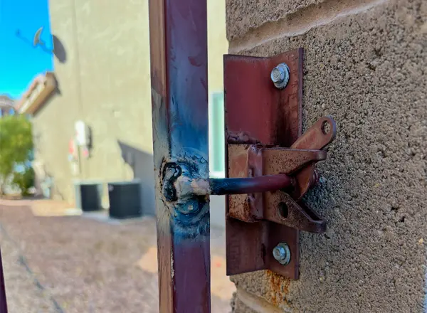 Locksmith welding service of repairing a metal gate latch